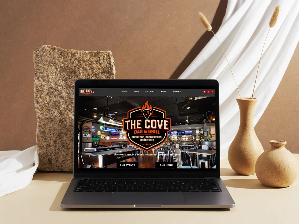 The Cove Bar & Grill storefront, shown on a laptop